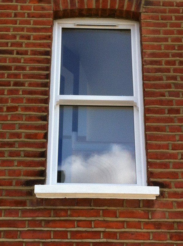 uPVC sash window on Victorian red brick house in Esher